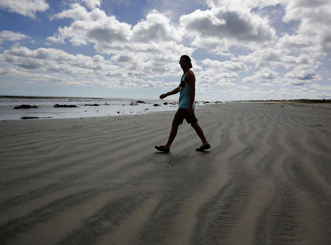 Garrett Croyle walks along Crescent beach after Hurricane Matthew on Friday, Oct. 8, 2016 in St. Augustine, FL. Matt Stamey/Gainesville Sun